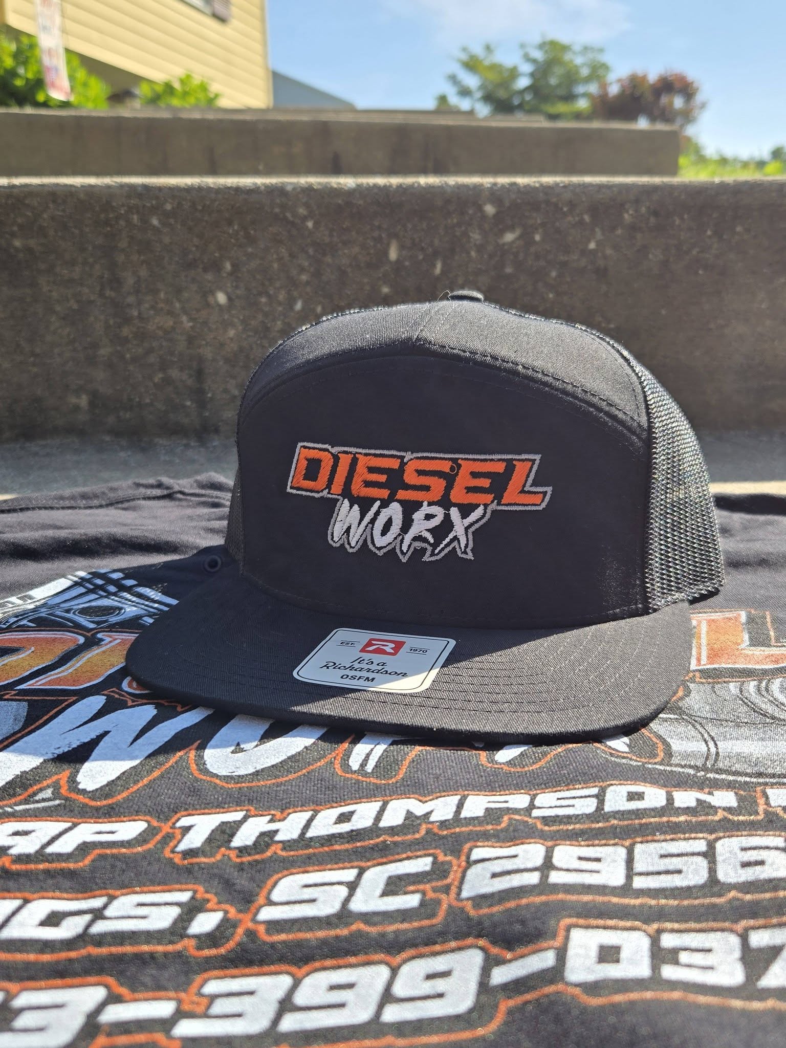 black embroidered hat with orange and white diesel repair logo