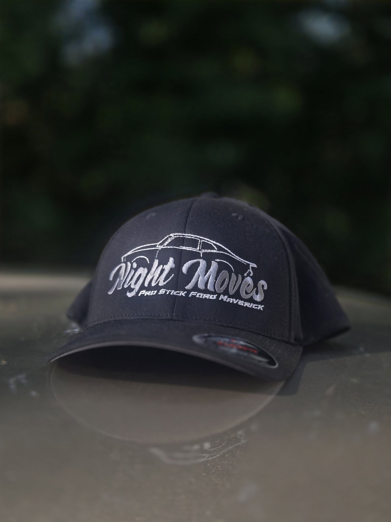 black embroidered hats with silver and white motorsports team logo